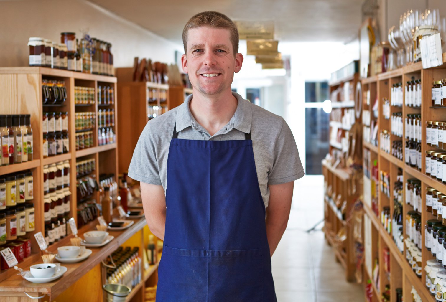Proud shop keeper in delicatessen